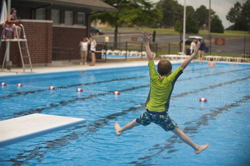 kid jumping in pool
